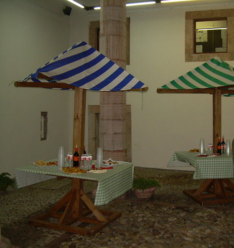 Mesas decoradas con pinchos y bebida.